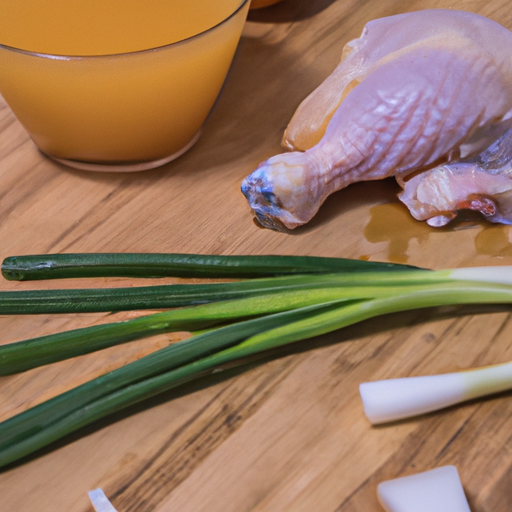 Fresh ingredients for making orange chicken, including chicken thighs, orange juice, and green onions